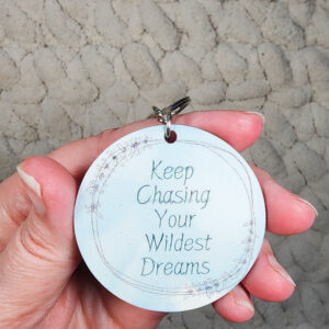 Keep Chasing Your Wildest Dreams Keychain on Blue Background-